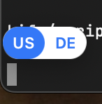 A blue circle with "US" in it and a white ellipse with "DE" in it. Both of them pop-up above the current courser position